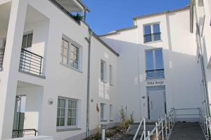 a white building with a sign that reads walkace at Villa Antje - Ferienwohnung 03 in Göhren