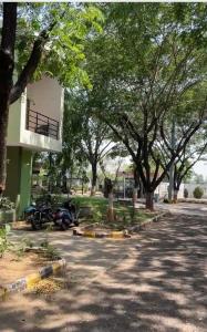 a parking lot with trees and a building at Samruddhi S1 homestay villa swimming or S3,S20 in Nagpur