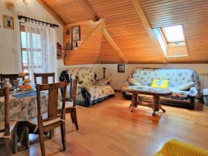 a living room with a couch and a table at Attic Old Town Apartment in Budva