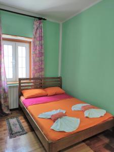 a bedroom with a bed with two towels on it at Attic Old Town Apartment in Budva