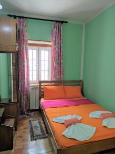 a bedroom with a bed with two towels on it at Attic Old Town Apartment in Budva