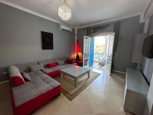 a living room with a couch and a table at APPARTEMENT RAYHAN Yasmine Hammamet in Hammamet