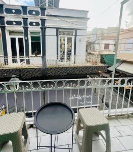 a balcony with two chairs and a table at City Corner Stay in Kavala
