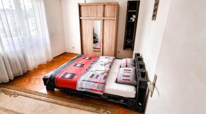 a bedroom with a bed in the corner of a room at 3pko City center apartment in Banja Luka