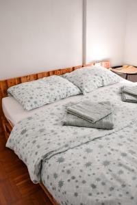 a bed with two pillows on top of it at 3pko City center apartment in Banja Luka