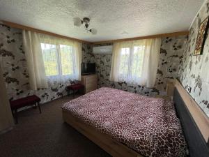 1 dormitorio con 1 cama con colcha roja en Holiday Home Lyubovo en Gabrovo