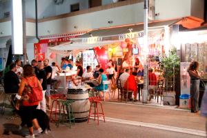 a group of people sitting outside of a restaurant at Aurora 2 in Lido di Pomposa