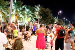 a crowd of people walking down a street at night at Aurora 2 in Lido di Pomposa
