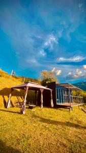 a small building on a hill with a grass field at TINY HOME in Copacabana