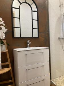 a bathroom with a white sink and a mirror at Le studio D'auguste- Cœur de Nîmes-chaleureux-emplacement idéal in Nîmes