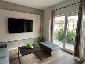 a living room with a couch and a tv at Apartment Bencic in Fažana