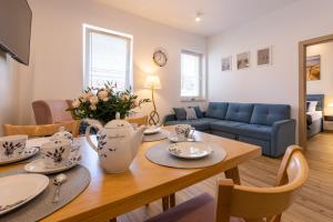 a living room with a table and a couch at Apartament STARS Ustka in Ustka