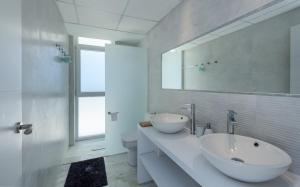 a white bathroom with a sink and a mirror at Villa Dona Julia 2410 Golf and Sea views in Casares +27 photos