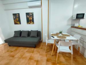 a living room with a couch and a table and chairs at Casas Holiday - Playa la Mata Laredo in La Mata +22 photos