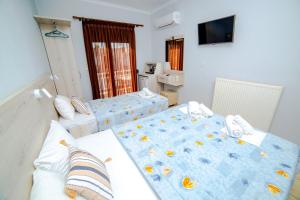 Postel nebo postele na pokoji v ubytování Hotel Zefyros