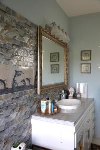 a bathroom with a sink and a mirror at Jannetta's @Whimhill Bed & Breakfast in Negril
