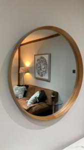 a mirror on a wall with a bed in a room at Gorgeous Central Hastings Old Town in Hastings