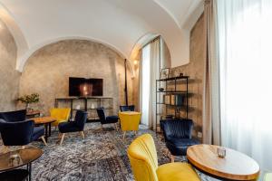 a lobby with tables and chairs and a television at Boutique Hotel Siglisberg in Štiavnické Bane