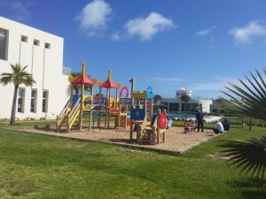a playground in a park next to a building at Savanah Beach Residence in Casablanca