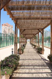a wooden pergola with a walkway at Apartment Carmentxu Gemelos 26 in Benidorm