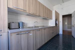 a kitchen with wooden cabinets and a sink at Luxury Apartment/Flat Edinburgh City Centre in Edinburgh