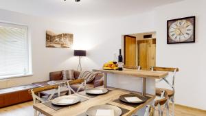 a living room with a table and a couch at Apartmán Mary in Vyšné Hágy