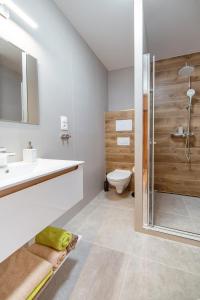 a bathroom with a sink and a toilet and a shower at Apartmán Mary in Štôla