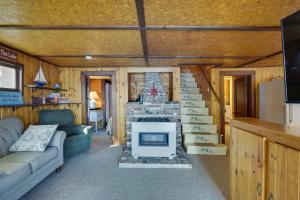 a living room with a fireplace in a tiny house at Rustic Poland Vacation Rental with Waterfront Deck! in Poland