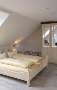 a bedroom with a large bed in a attic at Hotel Seehof Norderney OHG in Norderney