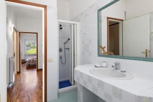 a white bathroom with a sink and a shower at Villa Gloria Guest House in Tovo San Giacomo +37 photos