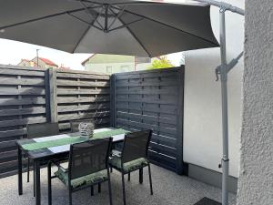 a table and chairs with an umbrella on a patio at Abrahama Green House in Władysławowo