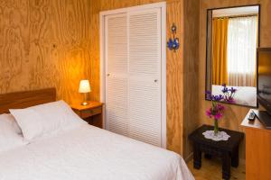 Postel nebo postele na pokoji v ubytování Del Pescador Hotel Cabañas