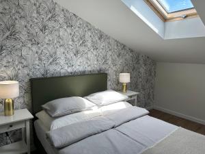 a bedroom with a bed and a wall mural at Abrahama Green House in Władysławowo