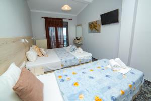 Postel nebo postele na pokoji v ubytování Hotel Zefyros