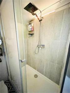 a shower with a glass door in a bathroom at Boutique Boat Stays Contemporary Barge in Bath