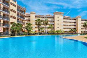 a large swimming pool in front of a large apartment building at Lopimar Guillen de Castro in Canet de Berenguer