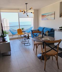 a living room with a couch and tables and chairs at Departamento en Antofagasta 2D+1B FULL in Antofagasta