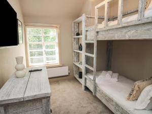 a bedroom with two bunk beds and a desk at Number 6 in Telford