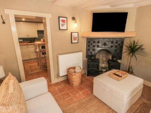 a living room with a couch and a fireplace at Number 5 in Telford