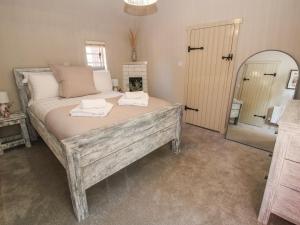 a bedroom with a bed with two towels on it at Number 7 in Telford