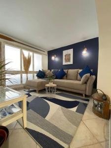 a living room with a couch and a table at Appartement La maison du pêcheur in Sainte-Maxime