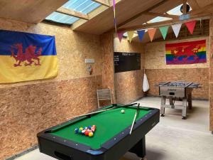 a room with a pool table and a ping pong ball at Cefn Ceiriog in Llangollen