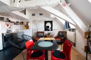 jadalnia ze stołem i czerwonymi krzesłami w obiekcie SOUVENIRS VIEUX LILLE Apartment 2 Chambres 24H24H Access w Lille