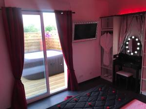 a bedroom with a bed and a sliding glass door at Saint-Avertin Maison la Tourangelle à partager en famille ou amis in Saint-Avertin