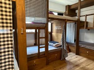 two bunk beds in a room with wooden floors at Wontonmeen in Hong Kong