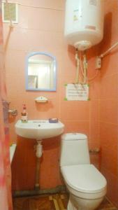 a bathroom with a toilet and a sink and a mirror at Apartment in Izyum Rizdvyana 9 in Izyum