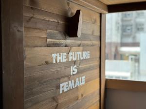 a wooden door with the future is female written on it at Wontonmeen in Hong Kong