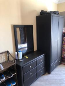a black dresser with a mirror on top of it at شاليه بقرية امواج الساحل الشمالي 3 غرفة Amwaj North Coast in El Alamein +10 photos