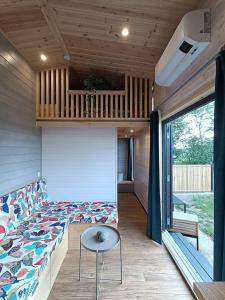 a bedroom with a bed and a table in a house at Tiny Roch' in Rochefort