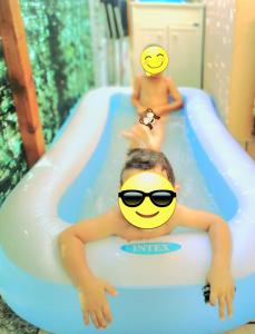 a woman in a pool with a smiley face in a inflatable at Alba Sweet in Alba Adriatica